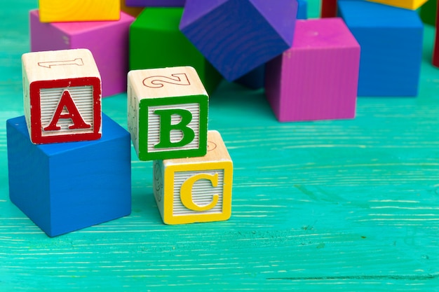 Photo alphabet blocks on wooden table.