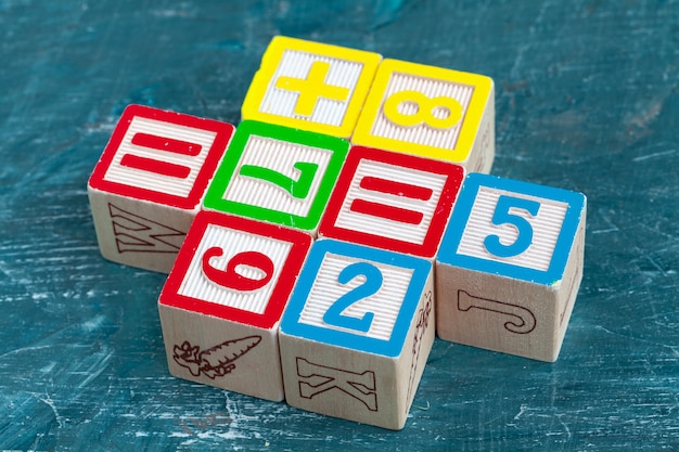 Alphabet blocks on wooden table.