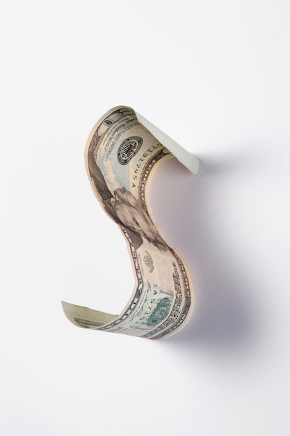 Alphabet made with paper currency against white background