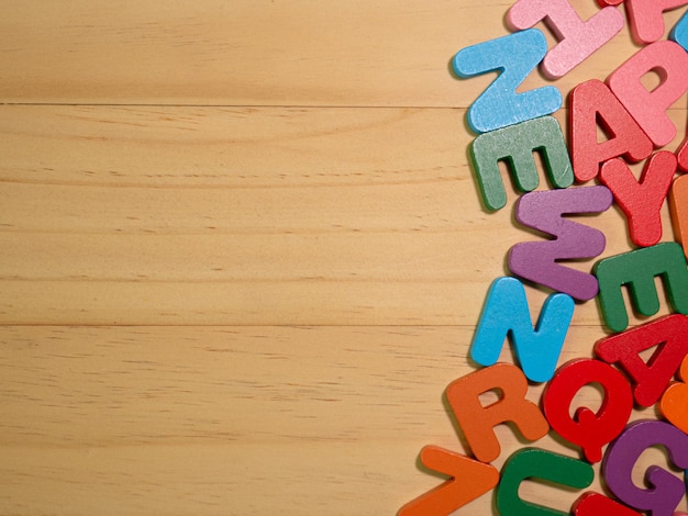 The alphabet multicolor  on wood table for education or kid concept