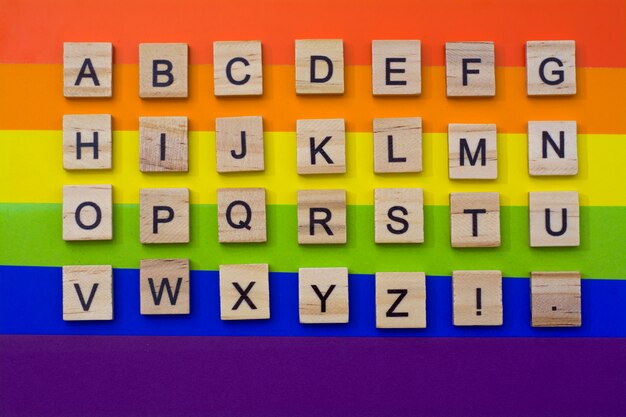 Photo alphabet in wooden letters on lgbt flag colours