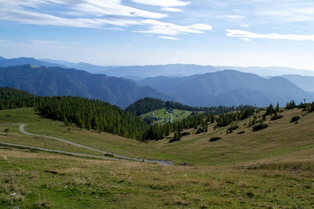 Alpine green meadows and forests on an autumn sunny day