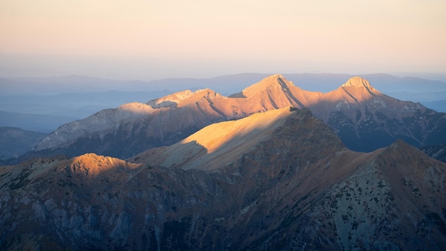 Alpine landscape with mountain ranges peaks catching last light during sunset Europe Slovakia