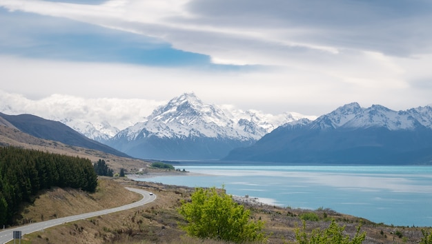 alpine vista with turquoise lake and mountains with mount cook in backdropmt cook new zealand