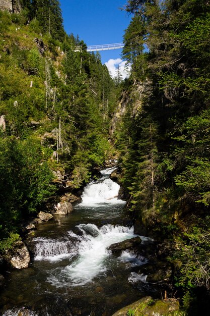 Alpine waterfall riesachwasserfall from lake riesachsee near schladming in austria