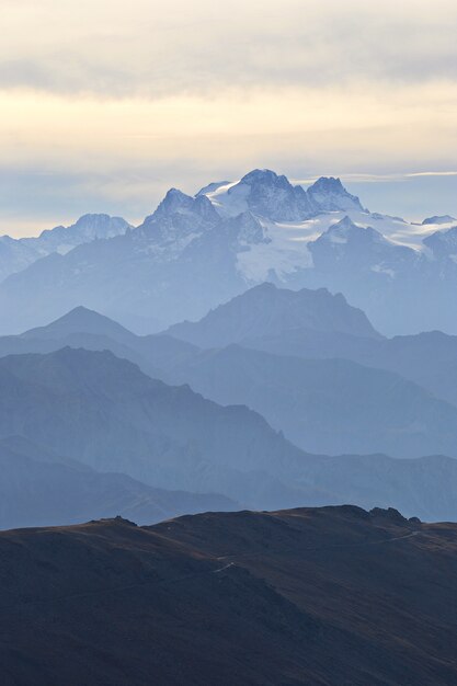 The Alps in autumn, sunset from the summit of rocky mountain peaks and ridges