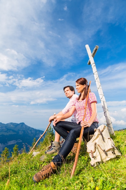 Alps - Hiking Couple takes break in mountains