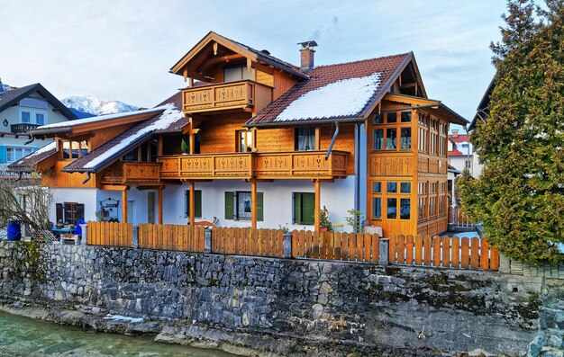 Alps, Partnach River and wooden Chalet in Bavarian style in winter Garmisch-Partenkirchen, Germany.