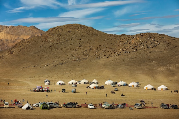 Altai mountains and valley with small Mongolian yurts and cars in Western Mongolia