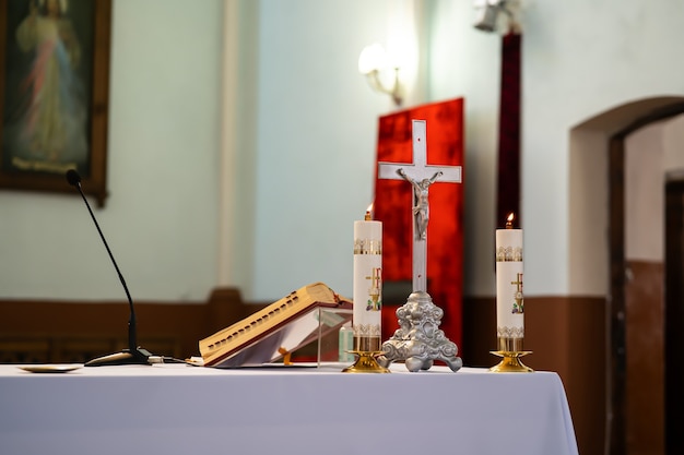 Photo the altar of a catholic priest with a bible on the table.