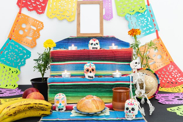 Altar decorated with pan de muerto and skulls. Day of the Dead. Mexican holiday.