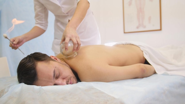 Alternative Asian Tibetan medicine, treatment using glass jars, close-up