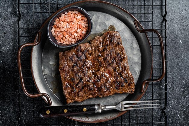 Photo alternative choice steak grilled skirt or machete beef meat black background top view