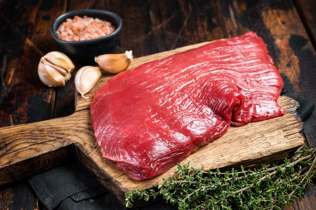 Alternative flank beef steak raw meat Wooden background Top view