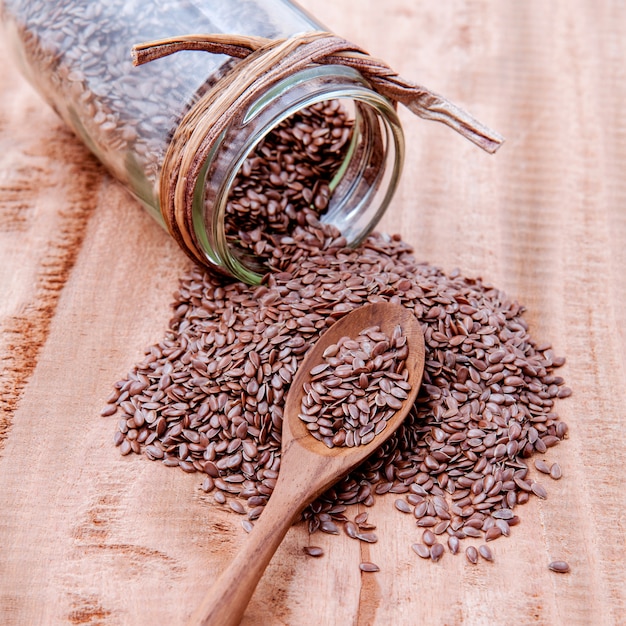 Alternative health care and dieting flax set up on rustic wooden background.