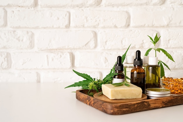 Alternative medicine, natural cosmetics. cbd oil and cannabis leaves cosmetics front view , copy space, mock up design