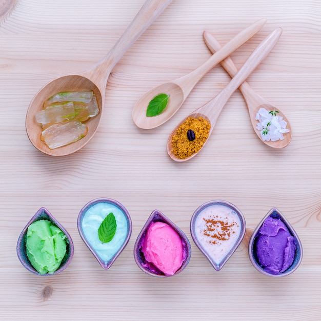 Alternative skin care and homemade scrubs on wooden table.