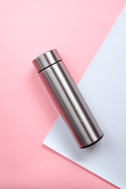 Photo aluminium reusable steel stainless eco thermo water bottle with mockup on pink white background