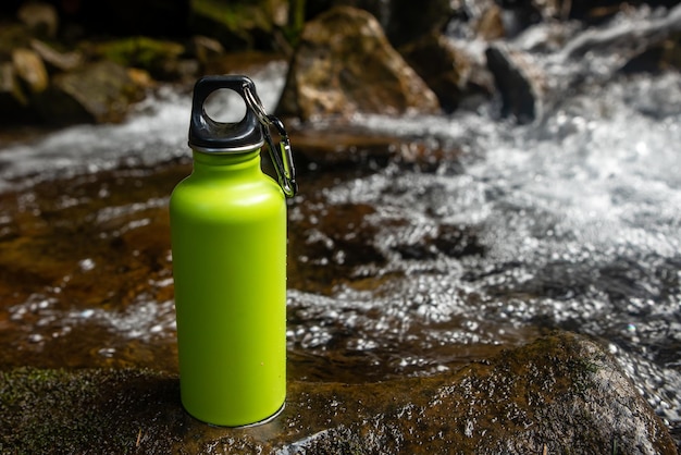 an Aluminium thermos Water Bottle in the nature background