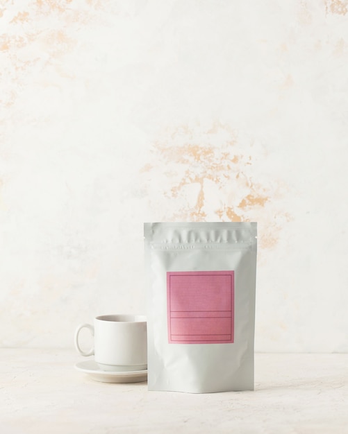 Photo aluminum bag for tea coffee with pink label for signature on a light background