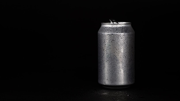 aluminum can with water drops on black