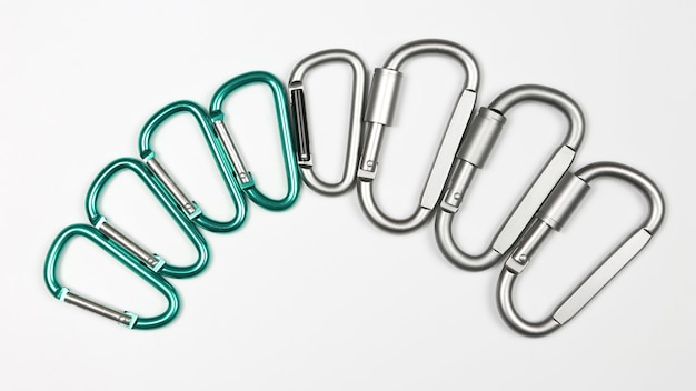 Aluminum carabiners in a row on white background