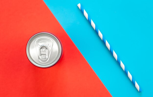 Photo aluminum drink or beverage can with pull ring on colored background flat lay