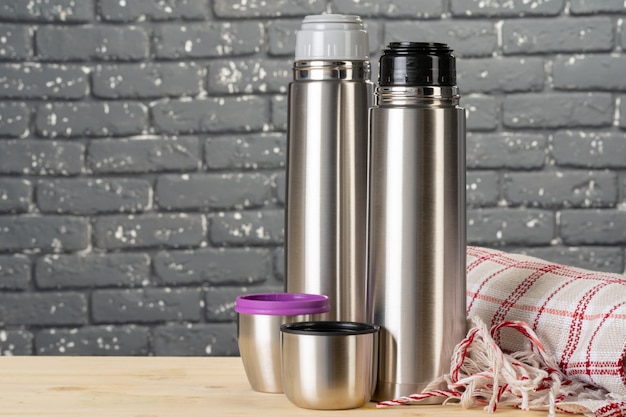 Aluminum metal thermos container bottle close up on table