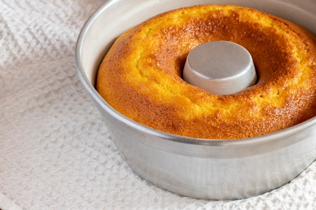 Aluminum pan with cornmeal cake to unmold