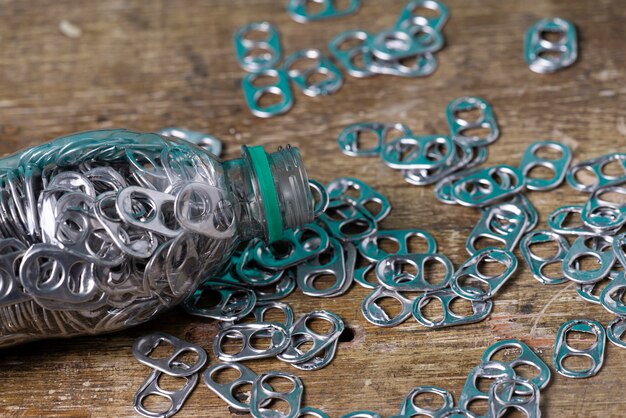 Photo aluminum pull tabs in a plastic bottle