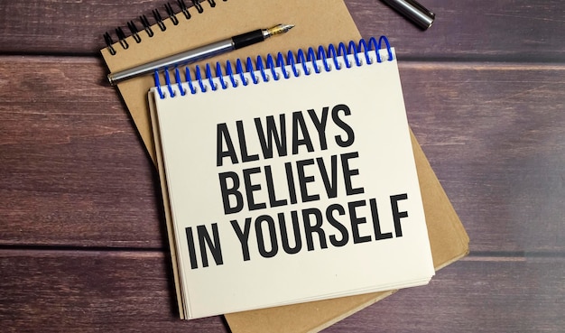 Photo always believe in yourself text on wooden background