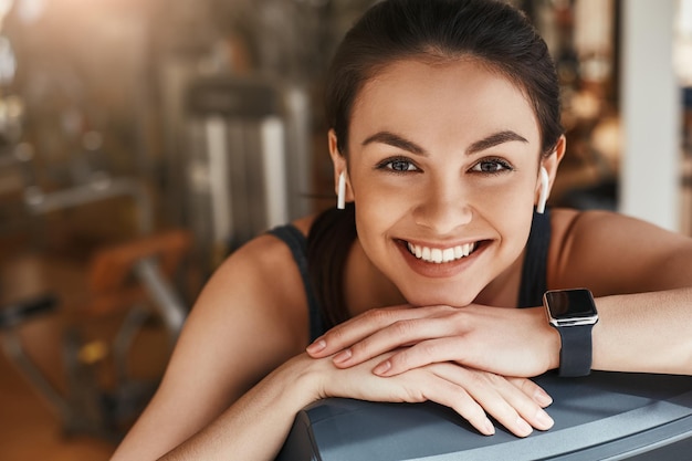 Always in good mood portrait of cute and cheerful woman with smart watch on her