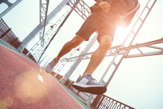 Always in great shape cropped photo of young man in sports clothing jogging on the