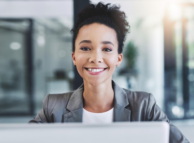 Always happy to be productive Cropped shot of an attractive young businesswoman in her office