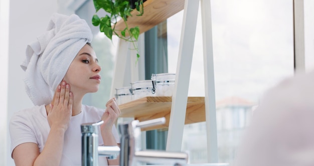 Always keeping my skin smooth and fresh Shot of a young woman cleaning her face