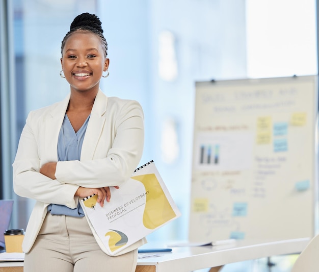 Always proud to present my ideas. Shot of a proud young businesswoman in her office holding a file of documents.