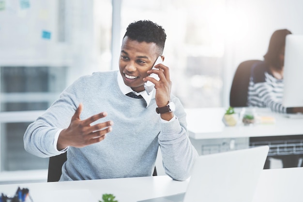 Always try to follow up on every task youve actioned Shot of a young businessman making a phone call at his office desk with a colleague working in the background