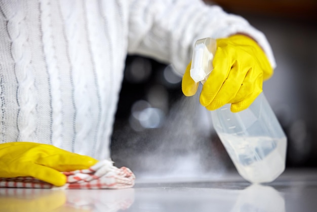 Always use a strong disinfectant Shot of a woman spraying her kitchen counter to clean it