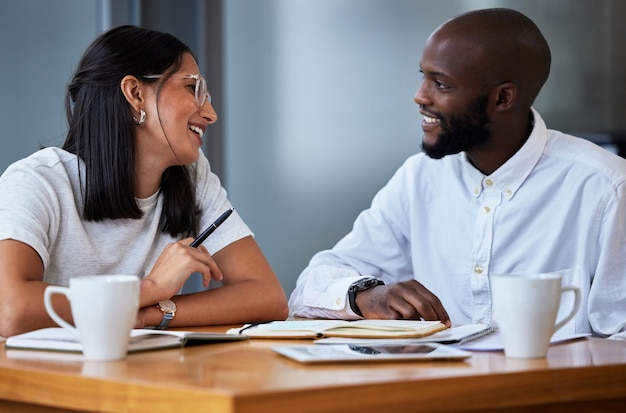 always winning in due time shot of two businesspeople sitting at a desk in a modern office