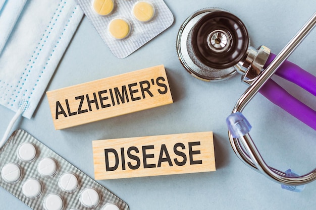 Photo alzheimer's disease written on wooden cubes on medical background