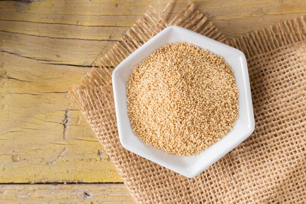 Amaranth beans in bowl on rustic wooden background