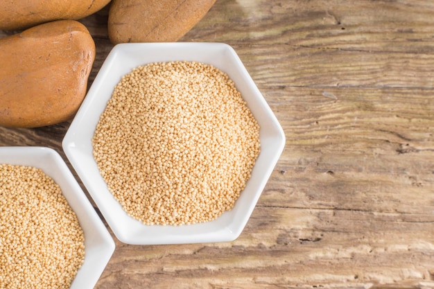 Amaranth beans in bowl on rustic wooden background