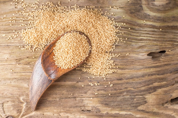 Amaranth beans in bowl on rustic wooden background