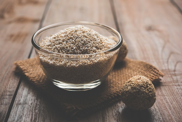 Amaranth or rajgira lahi in a bowl with sweet laddu. selective focus