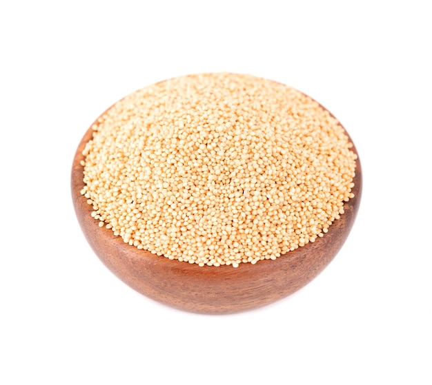 Amaranth seeds in wooden bowl, isolated  . Organic dry raw amaranth beans.