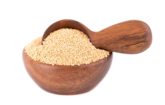 Amaranth seeds in wooden bowl and spoon, isolated  