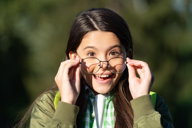 Amazed kid with backpack wear glasses back to school