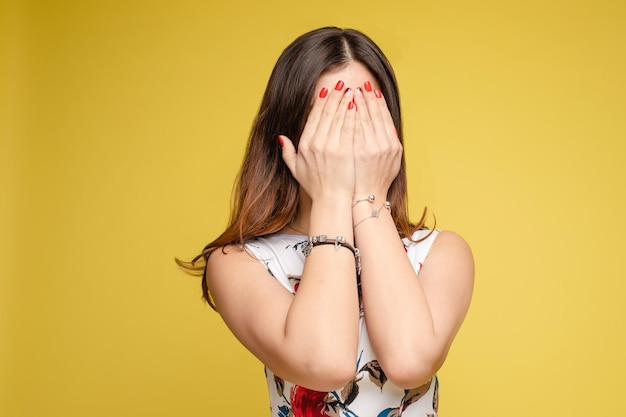 Amazed lovely woman covering face with hand