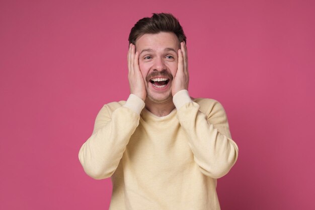 Amazed man feels shocked and surprised Great offer or big discount concept