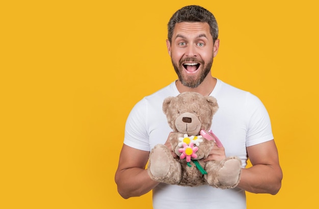 Amazed man hold valentine toy bear in studio man with toy bear for valentine day